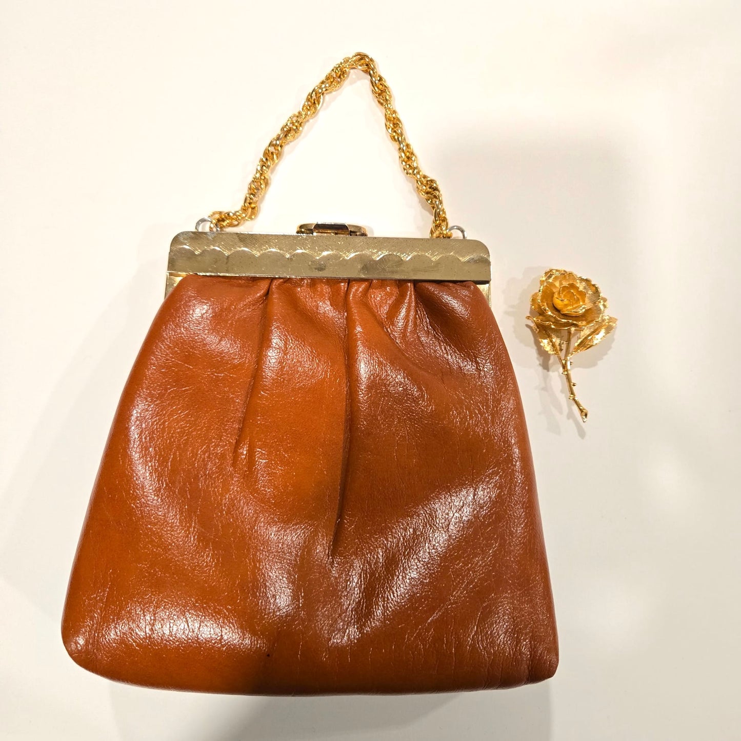 Vintage orange brown leather handbag with MONET Rose brooch pin and gold tone chain