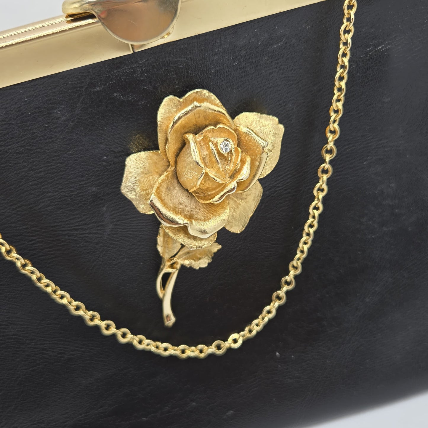 Vintage ETRA black leather clutch bag with ROSE Brooch pin and gold tone chain