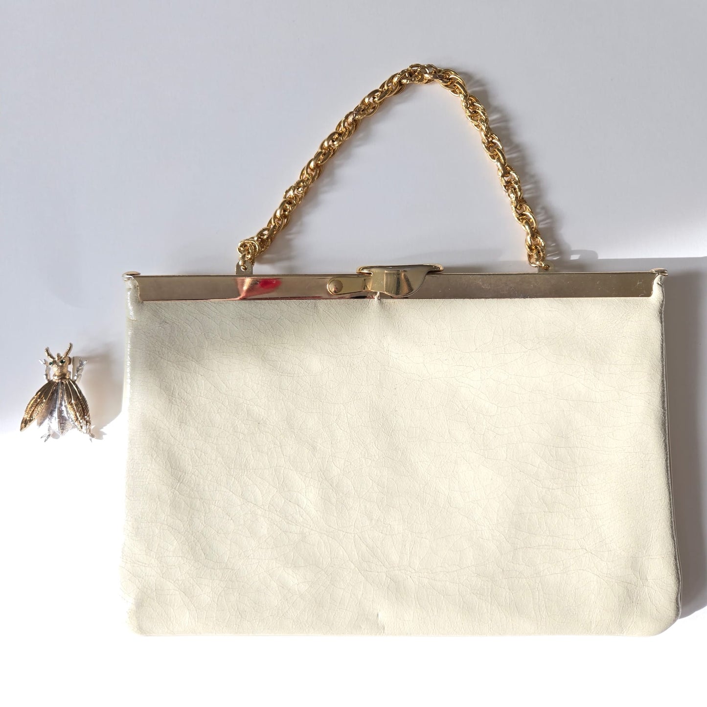 Vintage cream leather clutch bag with MONET Fly Bug Brooch pin and gold tone chain